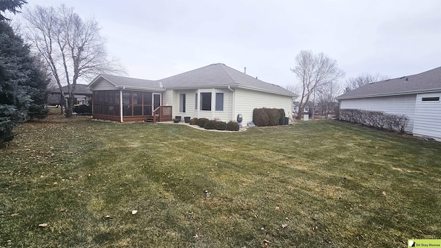 back of property featuring a yard and a sunroom