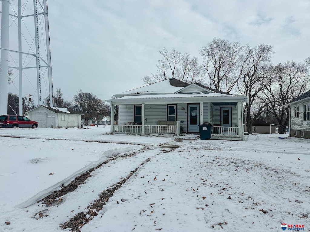 bungalow-style house featuring an outbuilding