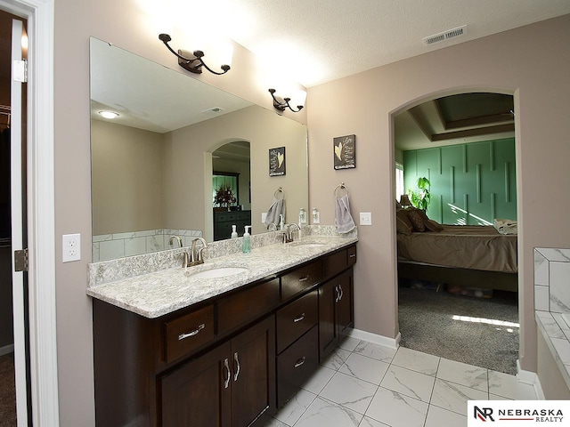 bathroom with vanity and a textured ceiling