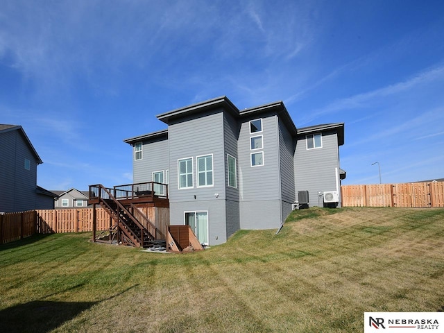 back of house with a wooden deck, central AC unit, and a lawn