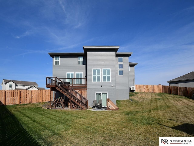 rear view of property featuring a deck and a lawn