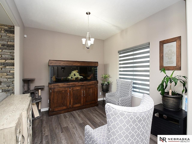 sitting room featuring dark hardwood / wood-style floors and a notable chandelier