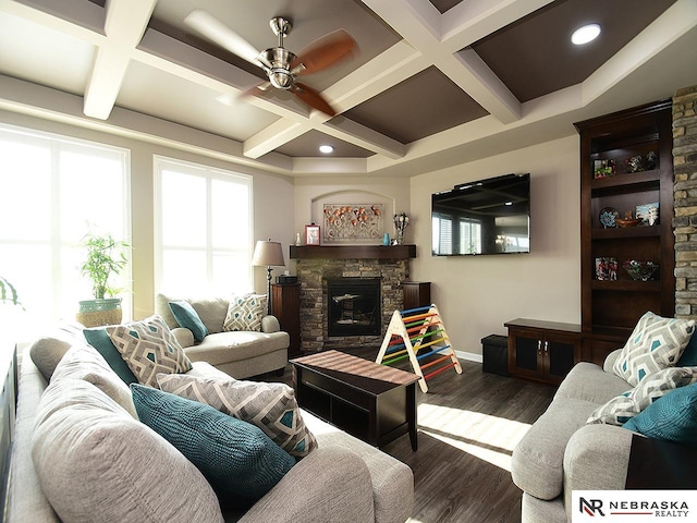 living room featuring coffered ceiling, a fireplace, dark hardwood / wood-style floors, and ceiling fan