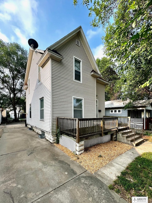 view of side of home featuring a deck