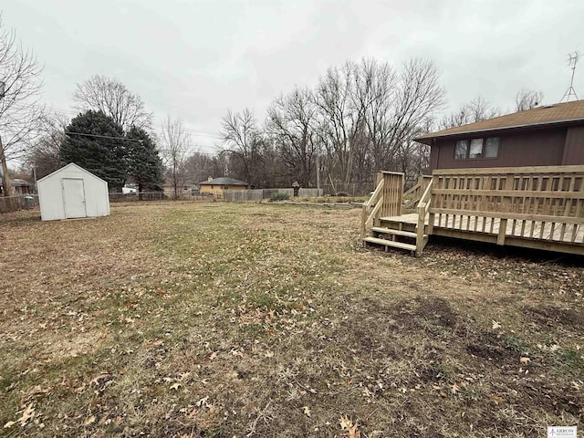 view of yard with a storage shed and a wooden deck