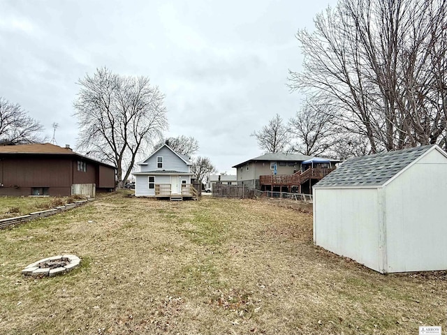 view of yard with a fire pit and a shed