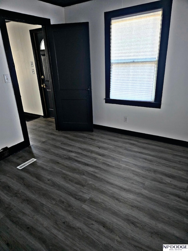 empty room with dark hardwood / wood-style floors