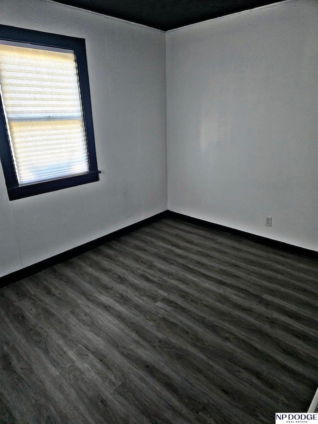 unfurnished room with dark hardwood / wood-style floors