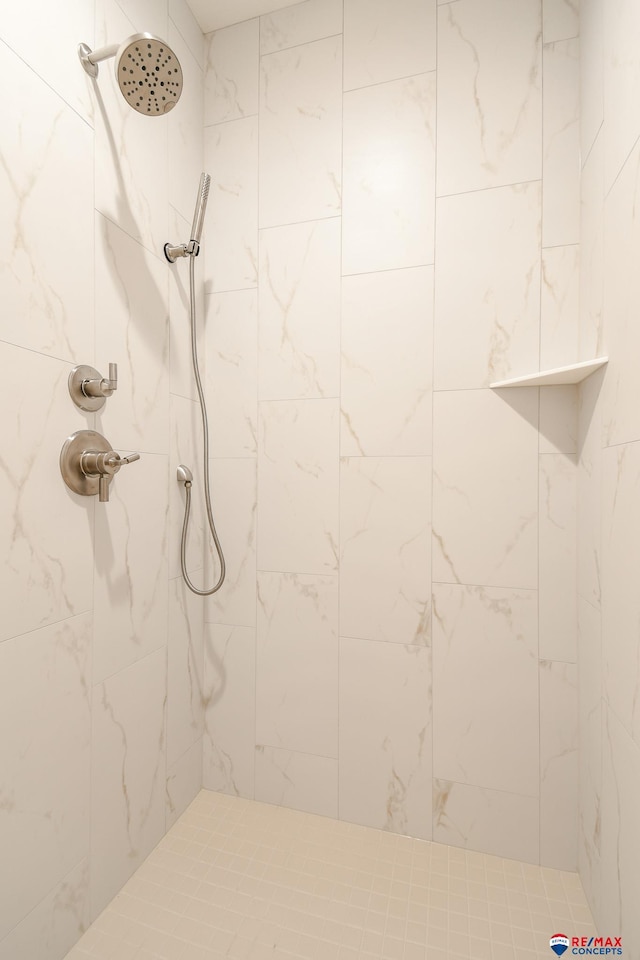 bathroom with a tile shower