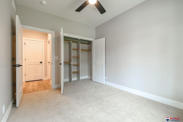 unfurnished bedroom with ceiling fan, a closet, and light carpet