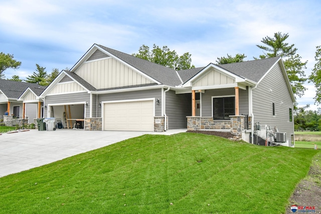 craftsman-style home with a front lawn, a porch, and a garage