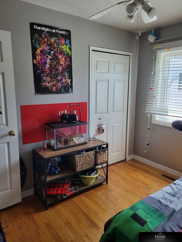 bedroom featuring a closet, ceiling fan, and hardwood / wood-style floors