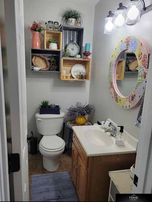 bathroom featuring vanity and toilet