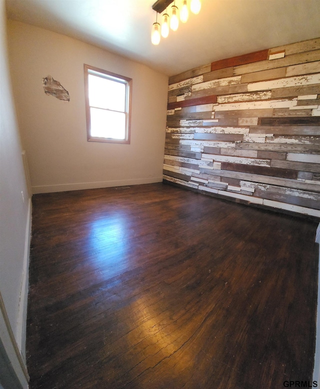 empty room with dark wood-type flooring