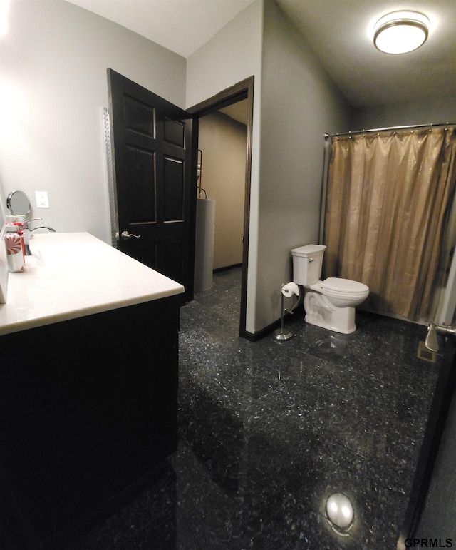 bathroom featuring vanity, toilet, and walk in shower