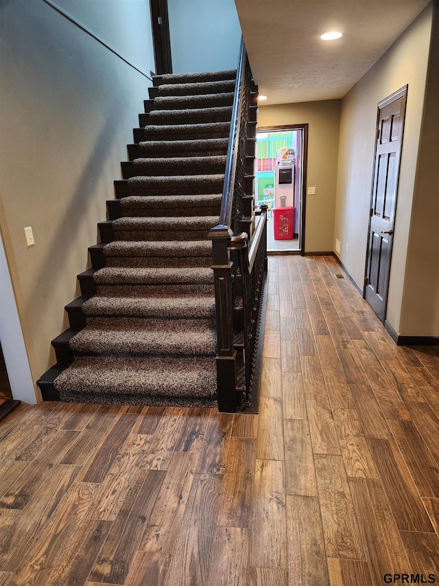 stairs with hardwood / wood-style flooring