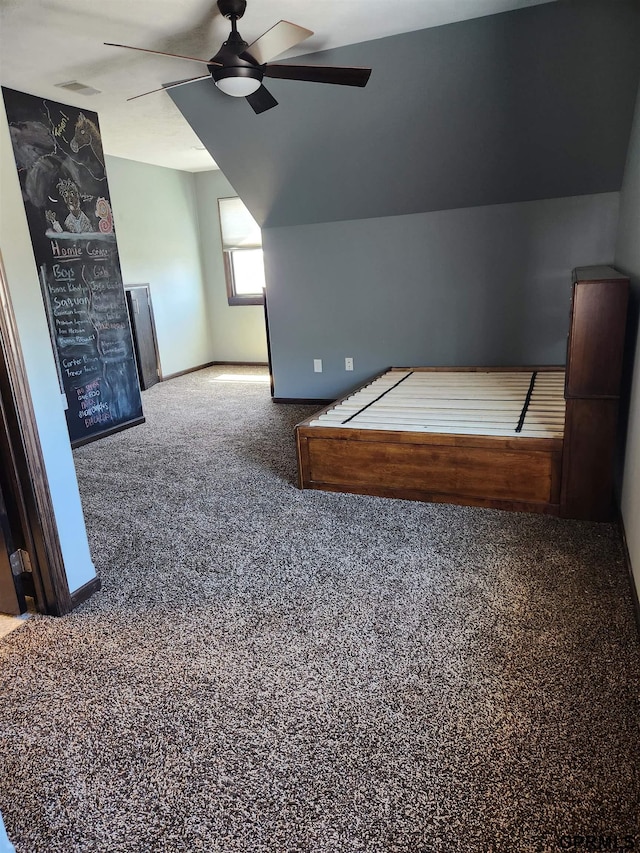 unfurnished bedroom with ceiling fan, carpet, and lofted ceiling