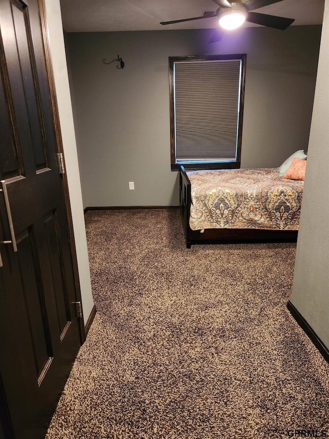 bedroom with dark colored carpet and ceiling fan