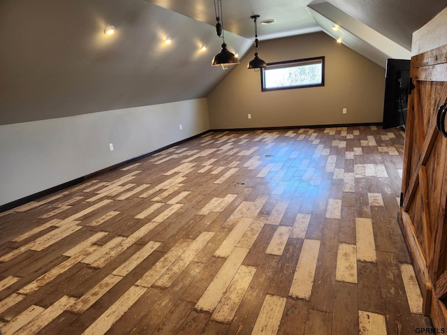 additional living space featuring dark hardwood / wood-style flooring and vaulted ceiling