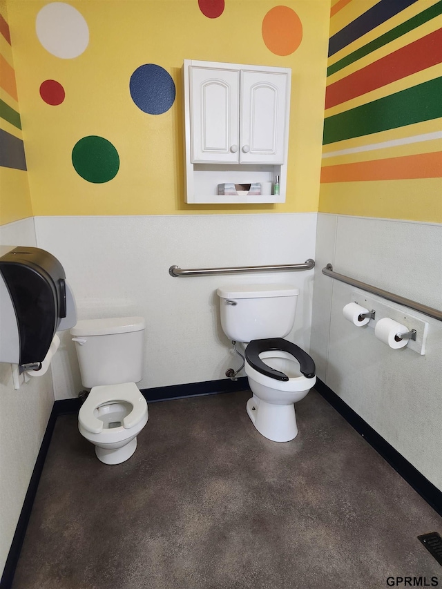 bathroom with toilet and concrete floors