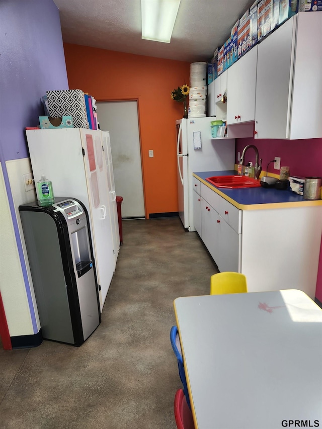 kitchen featuring sink and white cabinets