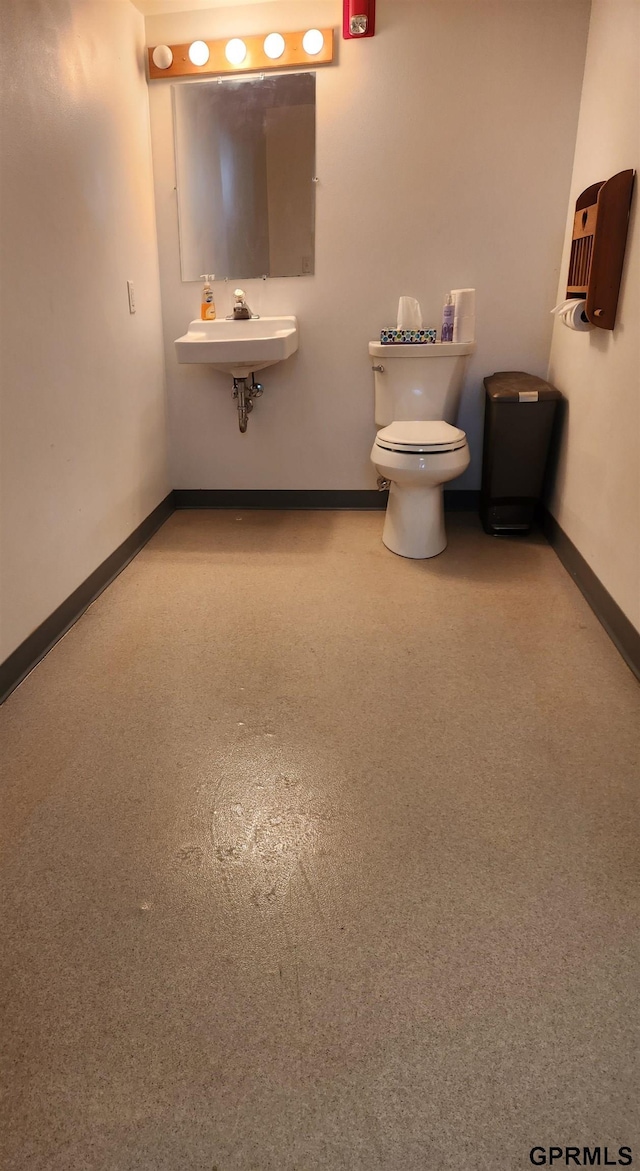 bathroom featuring toilet and sink