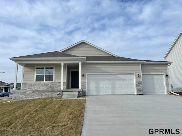 view of front of house featuring a garage and a front lawn