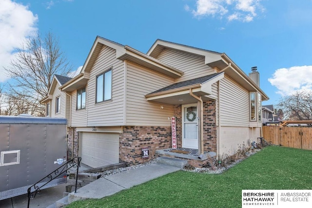 view of front of home featuring a front lawn and a garage