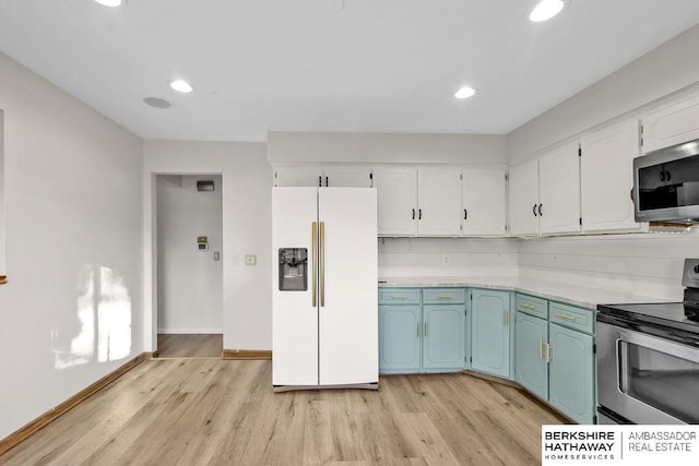 kitchen with backsplash, white cabinetry, stainless steel appliances, and light wood-type flooring