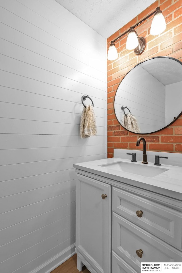 bathroom with a textured ceiling and vanity