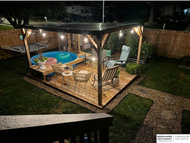 yard at twilight with a patio area and a fenced in pool