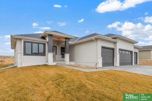 prairie-style house with a garage and a front lawn