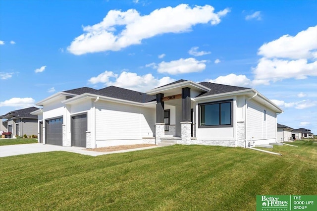 prairie-style house with a garage and a front lawn