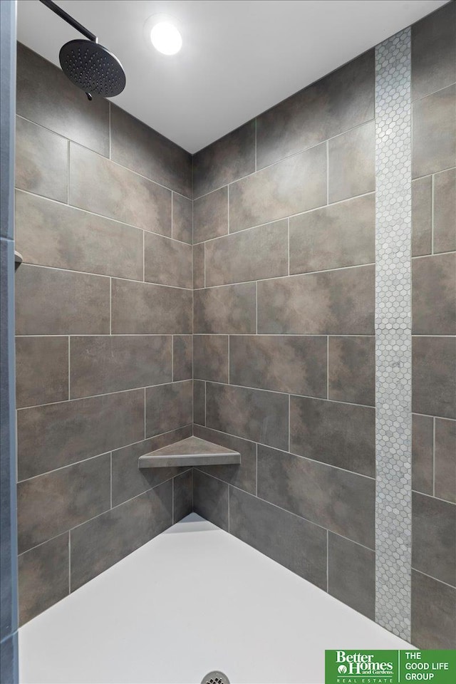 bathroom with a tile shower