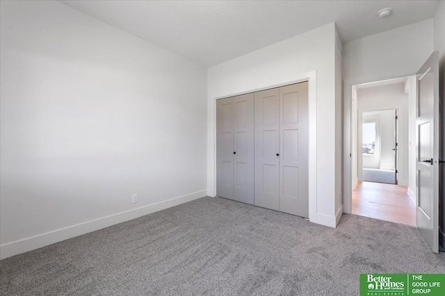 unfurnished bedroom with carpet flooring and a closet