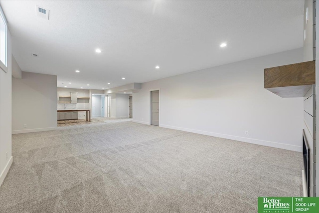 unfurnished living room featuring light carpet