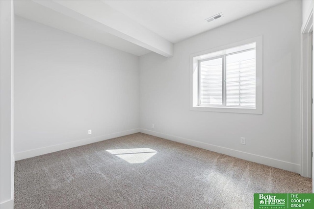 carpeted spare room with beamed ceiling