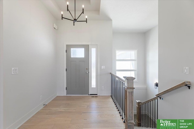 entryway featuring light hardwood / wood-style flooring and an inviting chandelier