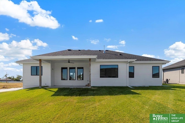 back of house featuring a lawn and ceiling fan