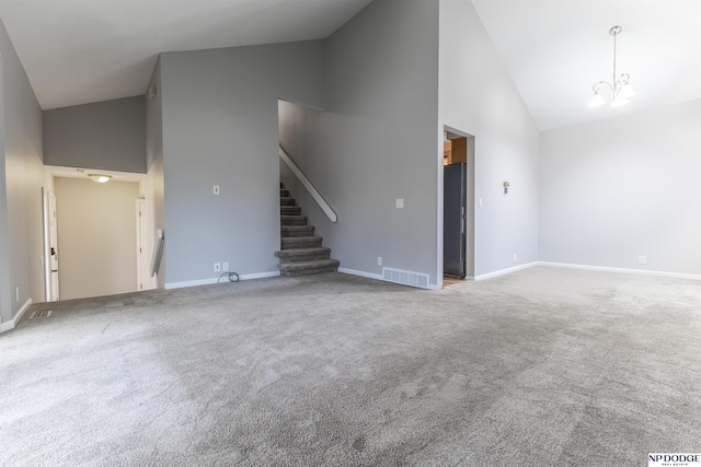 unfurnished living room with carpet floors, high vaulted ceiling, and an inviting chandelier