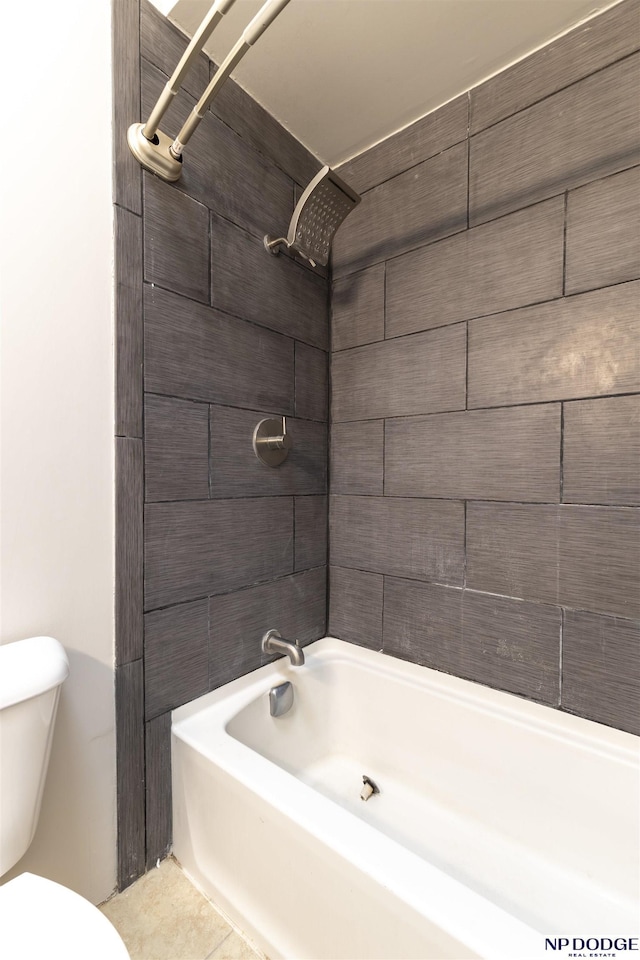 bathroom featuring tile patterned floors, toilet, and tiled shower / bath