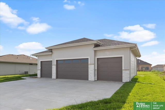 prairie-style home featuring a garage and a front lawn