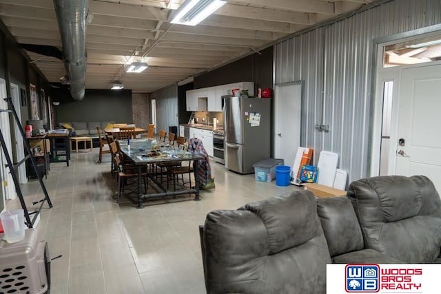 basement with stainless steel fridge and sink