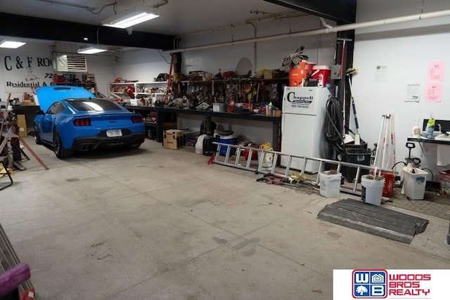 garage with a workshop area and white fridge