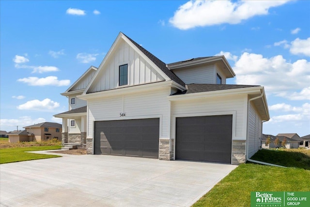 view of front of property with a front yard and a garage