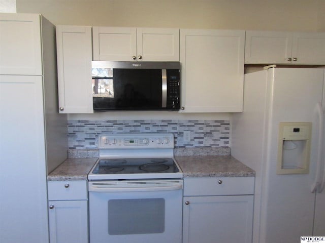 kitchen with tasteful backsplash, white cabinetry, and white appliances