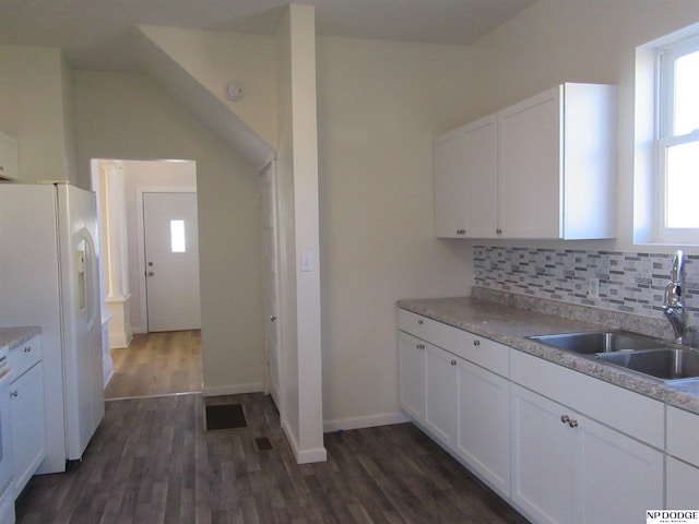 kitchen featuring white cabinetry, sink, dark wood-type flooring, tasteful backsplash, and white refrigerator with ice dispenser