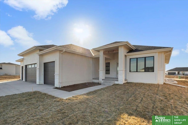 prairie-style home featuring a garage and a front yard