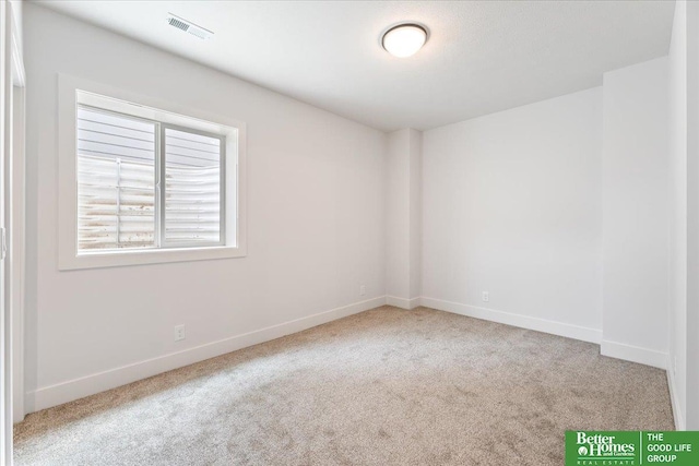 unfurnished room featuring light colored carpet