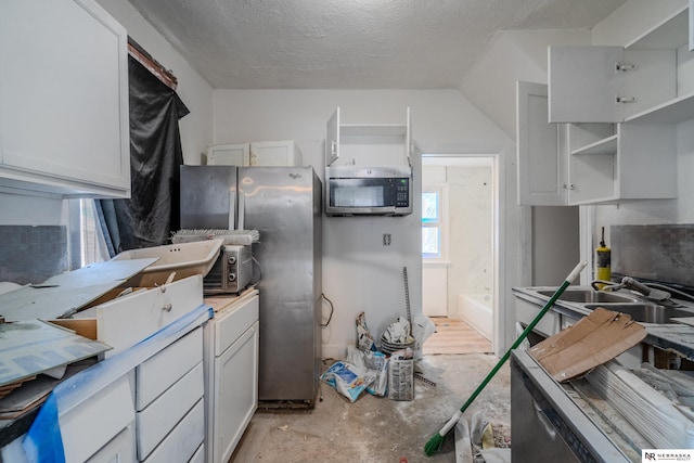 kitchen featuring white cabinetry, sink, and a textured ceiling